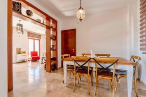 a dining room with a wooden table and chairs at La Dolce Rustica - Hillside Villa in Sutomore