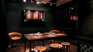 a dining room with a wooden table and chairs at Ruby Coco Hotel Dusseldorf by IHG in Düsseldorf