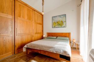 a bedroom with a bed and a wooden cabinet at La Dolce Rustica - Hillside Villa in Sutomore +32 photos