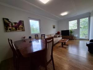 a living room with a table and a couch at TARA RIVER HOUSE in Odžića Glavica