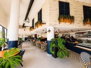 a restaurant with tables and chairs and plants at Caesar Blue Collection Nothern Cyprus Studios & Spa Resort in Kaimakli