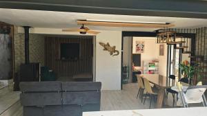 a living room with a table and a dining room at Maison de village in Copponex +7 photos