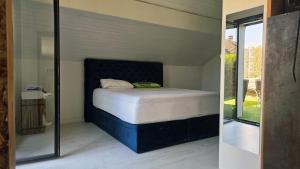 a bedroom with a bed in the corner of a room at Maison de village in Copponex