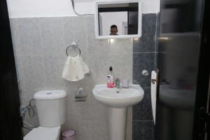 a bathroom with a sink and a toilet and a mirror at Spacious 2BR Apartment with Moroccan Salon near Aquaparc Tamaris Casablanca in Casablanca