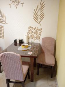 a table with two chairs and a bowl of food on it at Tića in Laćarak
