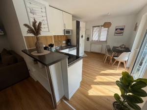 a kitchen with a island in the middle of a room at BOHO Apartment Skye in Bad Reichenhall