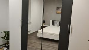 a bedroom with a bed and a mirror at Feriendomizil Sasse in Wusterwitz