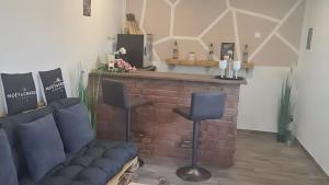 a living room with a couch and a brick fireplace at Feriendomizil Sasse in Wusterwitz