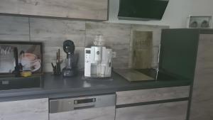 a kitchen counter with a coffee maker on it at Feriendomizil Sasse in Wusterwitz +12 photos