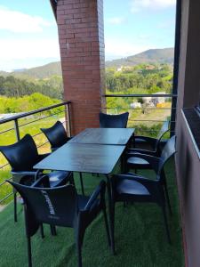 a table and chairs on a balcony with a view at Gure Bidetxe in San Andrés