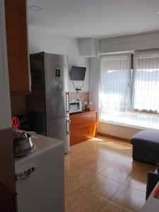 a kitchen with a stainless steel refrigerator and a window at Gure Bidetxe in San Andrés