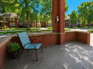 a blue chair sitting next to a brick wall at Boulevard Park Apartments in Erie