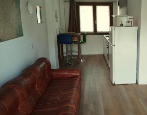 a living room with a couch and a refrigerator at NaturalmenteLucia 2 in Cologno al Serio