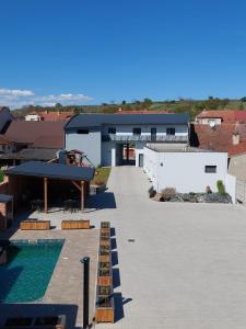 a large parking lot with a pool and a building at Apartmány Zelnice Velké Pavlovice in Velké Pavlovice