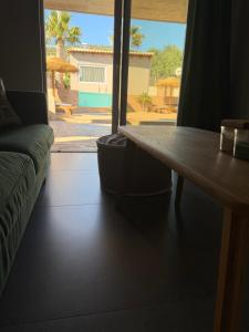 a living room with a table and a large window at Jimmy's place in Artemida
