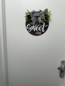 a door with a sign that reads home sweet home at IL Mulino House D, keukenhof in Hillegom