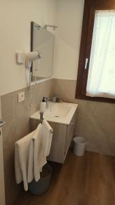 a bathroom with a sink and a mirror at NaturalmenteLucia 2 in Cologno al Serio +9 photos