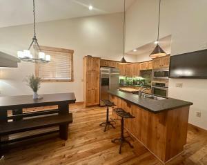 a kitchen with a large island with a counter top at Cozy Light Filled Truckee Downtown in Truckee