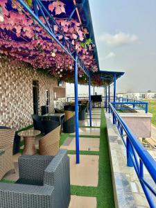 a patio with tables and chairs and flowers at Chinbell Luxury Hotel & Suites in Lekki