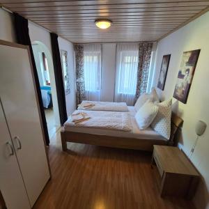 a bedroom with a bed and a wooden floor at Haus Sofia in Cochem