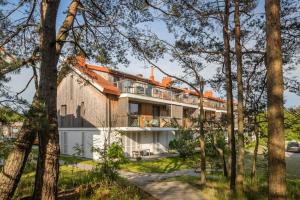 a large house with trees in front of it at Pino Home in Neringa