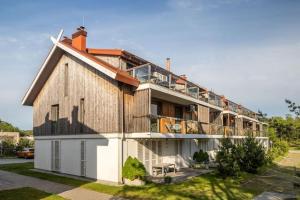 a large building with a balcony on top of it at Pino Home in Neringa +10 photos