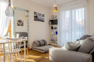 a living room with a couch and a table at Pino Home in Neringa
