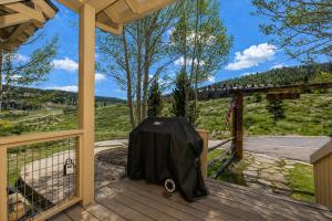 a screened in porch with a table on it at 100 Fairway Lane in Granby +30 photos