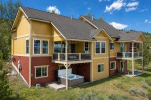 a house with a hot tub in the yard at 100 Fairway Lane in Granby