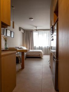 a bedroom with a bed and a table in a room at Downtown photographer's studio in Korinthos +14 photos
