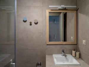 a bathroom with a sink and a mirror at Downtown photographer's studio in Korinthos