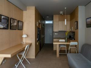a living room and kitchen with a table and chairs at Downtown photographer's studio in Korinthos