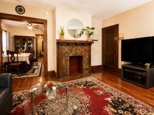 a living room with a fireplace and a tv at Spacious Frontier Park Apartment in Erie
