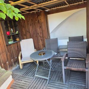 a patio with a table and chairs on a deck at Haus Sofia in Cochem