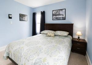 a bedroom with a large bed and a window at Spacious Frontier Park Apartment in Erie