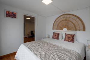 a bedroom with a large white bed with pillows at Casa Dos Arcos Oceanfront Apartments in Arcos +39 photos