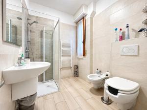 a bathroom with a sink and a toilet and a shower at Casa Berso' a Marina di Cecina by Zoom In Earth in Marina di Cecina +17 photos