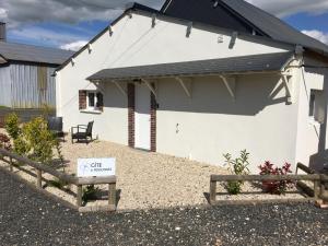 a white house with a sign in front of it at Gîte 6 personnes in Digny