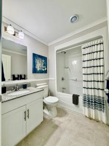 a bathroom with a toilet and a tub and a sink at Oceanfront Escape on the Cabot Trail by Cabotopia in Chéticamp +54 photos