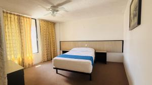 a bedroom with a bed and a window at Hotel Plaza del Ángel in Huajuapan de León