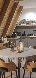 a dining room table with chairs and a kitchen at Hill House Žabljak in Žabljak +28 photos