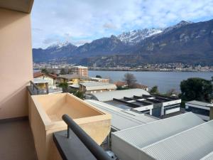 a balcony with a view of a city and mountains at Un sogno tra lago e monti in Pescate