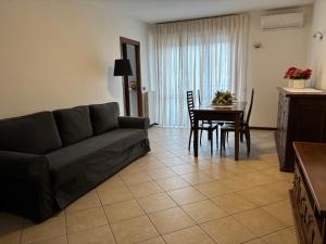 a living room with a couch and a table at Un sogno tra lago e monti in Pescate +13 photos