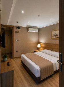a bedroom with a large bed and a television at Prens Hotel Istanbul by GKRY Hotels Group - Tram And Metro Stops Are Just a Few Min Walk Away in Istanbul