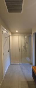 a walk in shower in a room with a glass door at Cosy Holidays in Trou aux Biches