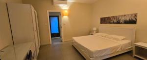 a bedroom with a white bed in a room at Cosy Holidays in Trou aux Biches