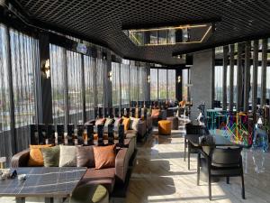 a lobby with couches and tables and large windows at QUALA Hotels in Aksaray
