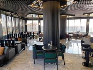 a lobby with tables and chairs in a building at QUALA Hotels in Aksaray +44 photos