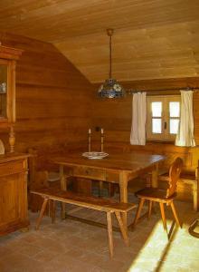 a dining room with a wooden table and a bench at Mountain House With Sauna In Sachrang in Sachrang