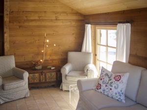 a living room with two chairs and a window at Mountain House With Sauna In Sachrang in Sachrang
